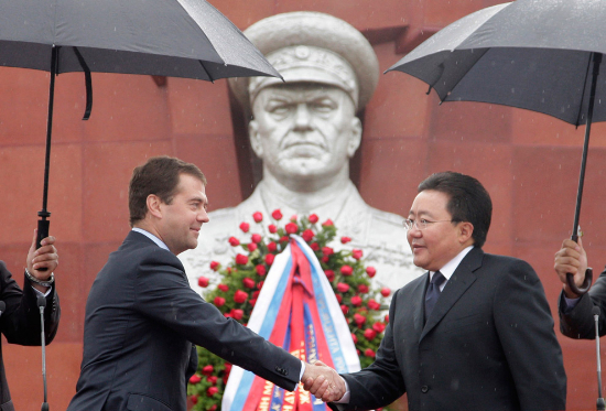 Russian President Dmitry Medvedev, left, and Mongolian President Elbegdorj Tsakhia shake hands during a ceremony marking the 70th anniversary of the joint victory of Soviet and Mongolian forces in the battle of Khalkin Gol, in Ulan Bator, Mongolia, on Wednesday, Aug. 26, 2009. A monument to Soviet Marshal Zhukov is at the background. (AP Photo/RIA-Novosti, Dmitry Astakhov, Presidential Press Service).